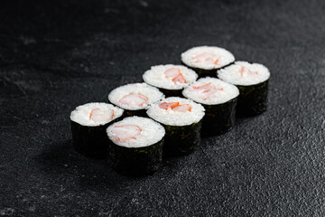 Sushi Rolls Set, maki, philadelphia and california rolls, on a Black background.