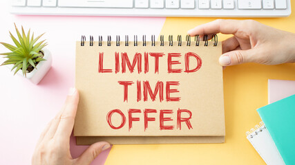 Text Limited time offer on white paper book and office supplies on blue desk, business concept