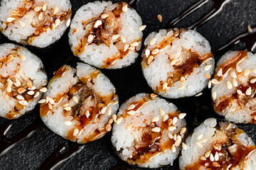 Sushi Rolls Set, maki, philadelphia and california rolls, on a Black background.