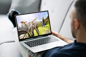 Young Man Lying On Sofa Watching Video