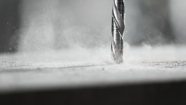 Super slow motion of detail of a drill bit drilling into concrete. Filmed on very high speed cinema camera, 1000 fps.