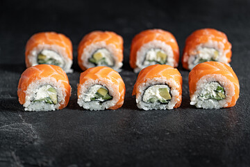 Sushi Rolls Set, maki, philadelphia and california rolls, on a Black background.