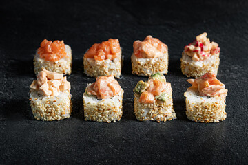 Sushi Rolls Set, maki, philadelphia and california rolls, on a Black background.