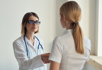 the patient came to the doctor with a stethoscope on a light background