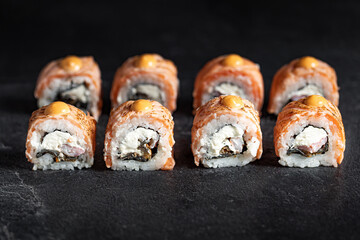 Sushi Rolls Set, maki, philadelphia and california rolls, on a Black background.