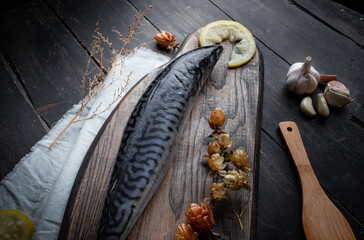 Fresh raw mackerel on the kitchen board. Old textured wooden table. Top view.