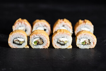 Sushi Rolls Set, maki, philadelphia and california rolls, on a Black background.