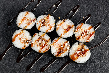 Sushi Rolls Set, maki, philadelphia and california rolls, on a Black background.
