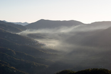 Obraz premium Andalusian mountain landscape. Sunrise with fire smoke and fog.