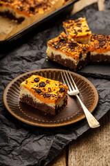 Delicious pumpkin cake with cheese cream and cacao or chocolate on the top