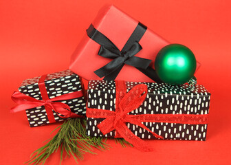 Gifts with Christmas decoration on red background
