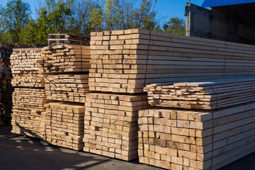 Wood planks for sale. Stacks of processed wood at the timber yard