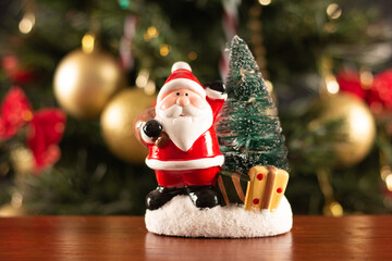 Santa Claus decoration on a christmas tree blurry background. Christmas party.