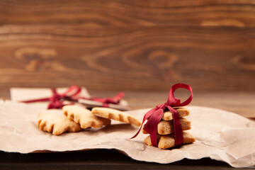Christmas gingerbread cookies on dark wooden background.