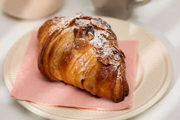 Homemade almond croissant and coffee