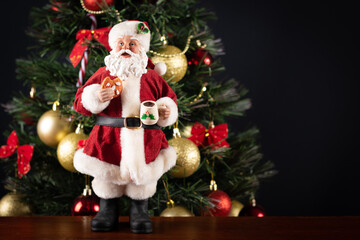 Santa Claus decoration on a christmas tree blurry background. Christmas party.