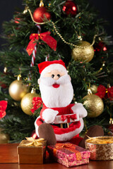 Santa Claus decoration on a christmas tree blurry background. Christmas party.