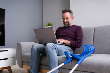 Injured Man With Broken Leg And Crutches