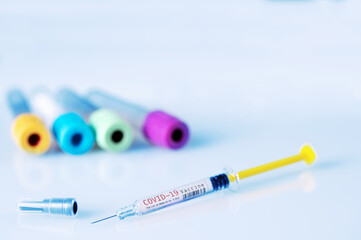 Close up of a Covid-19 Vaccine syringe on laboratory background. Copy space