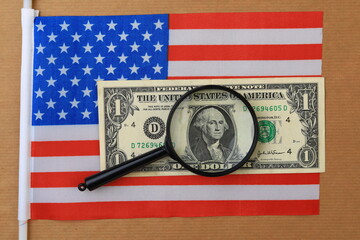 US dollars and magnifying glass as a symbol of the search for mo