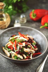 Salad with chicken breast, red beans, bell peppers, onions, walnuts and cilantro.