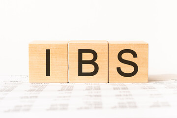 Word ibs. Wooden small cubes with letters isolated on white background with copy space available.Business Concept image.