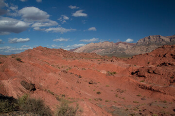 The red canyon. View of the arid desert, valley, red sandstone and rocky formations under a deep blue sky.