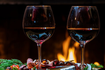 Two glasses of wine on fire background, dolly shot
