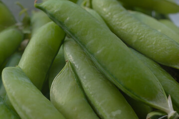 a macro picture of pod peas, ready for consumption decomposed in a chaotic order