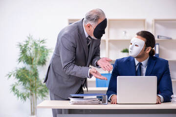 Old boss and young male employee wearing masks