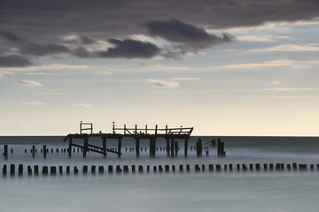 Fototapeta na wymiar Broken pier at Baltic sea.