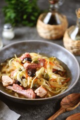 Traditional Russian soup Solyanka with smoked ribs, pork, cabbage, olives and capers.