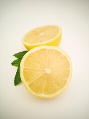 Yellow, vibrant, colorful citrus. Juicy fruit with mint leaves on white background