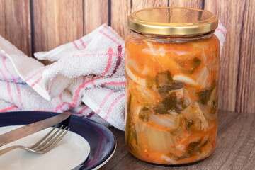 Kimchi Jar, typical spicy Korean food in a rustic setting ready to serve on a plate.