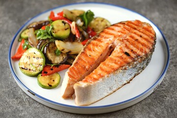 Grilled salmon steak with grilled salad of zucchini, eggplant, bell peppers, onions, garlic, cilantro, olive oil and wine vinegar.