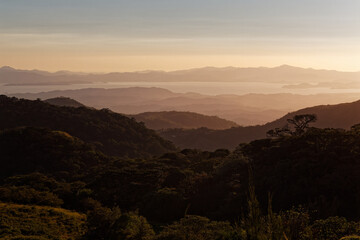 Fototapeta na wymiar Evening landscape from Monte Verde in Costa Rica, mountains and green forests, rainforest and bue sky with the clouds. Sunset or sunrise scenery