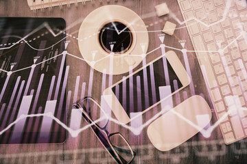 Multi exposure of forex graph hologram over desktop with phone. Top view. Mobile trade platform...