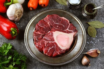 Raw beef shank with vegetables and garlic.