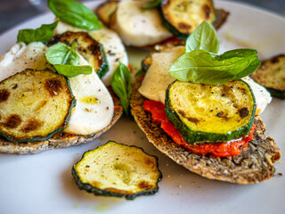 Mediterranean crostini with grilled zucchini, mozzarella and basil