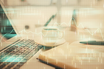 Double exposure of financial chart drawing and desktop with coffee and items on table background. Concept of forex market trading