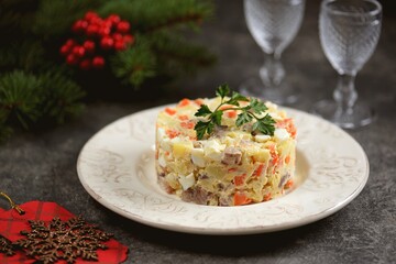 Festive salad with salted herring, boiled potatoes, eggs, onions and carrots.