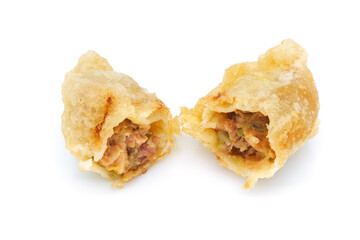 Chinese fried dumpling stuffed with pork meat and mixed vegetables, opened so as to reveal filling, isolated on a white background. Typical chinese food in restaurants or take away fast food. Close up