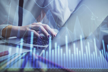 Double exposure of woman hands typing on computer and financial graph hologram drawing. Stock market analysis concept.