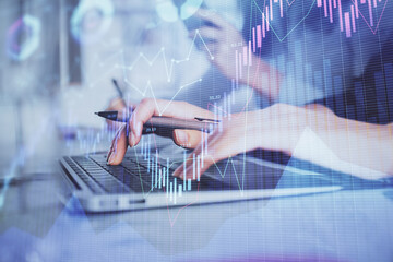 Multi exposure of woman hands typing on computer and financial graph hologram drawing. Stock market analysis concept.