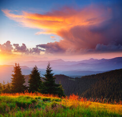 Naklejka na ściany i meble Exotic landscape in the mountains at sunset. Picture of colorful cloudy sky.
