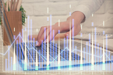 Multi exposure of woman hands typing on computer and forex chart hologram drawing. Stock market analysis concept.