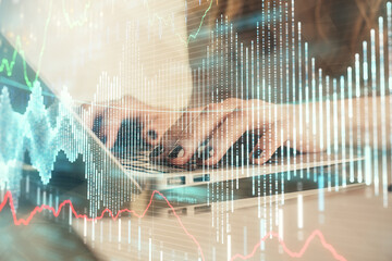 Double exposure of woman hands typing on computer and forex chart hologram drawing. Stock market invest concept.