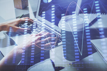 Double exposure of woman hands typing on computer and forex chart hologram drawing. Stock market invest concept.