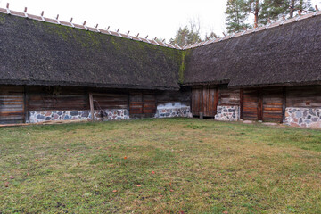 Fototapeta na wymiar The medieval farm was built of logs