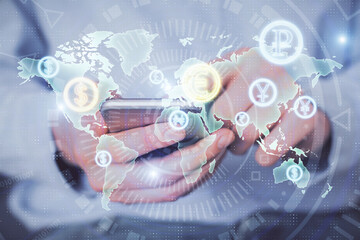 Fototapeta premium Double exposure of man's hands holding and using a digital device and forex graph drawing. Financial market concept.